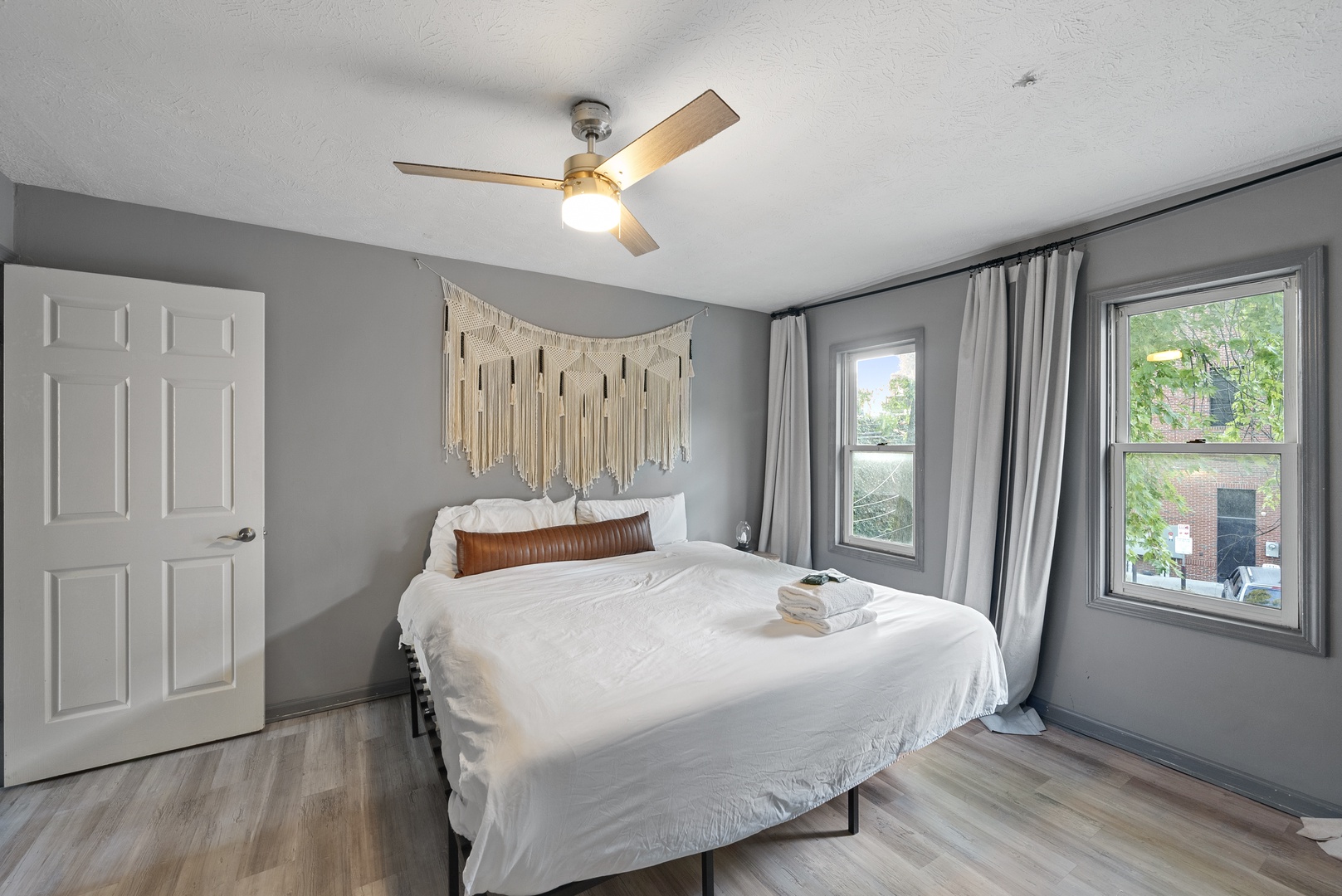 Recharge in the second bedroom’s cozy queen bed after a day on the town