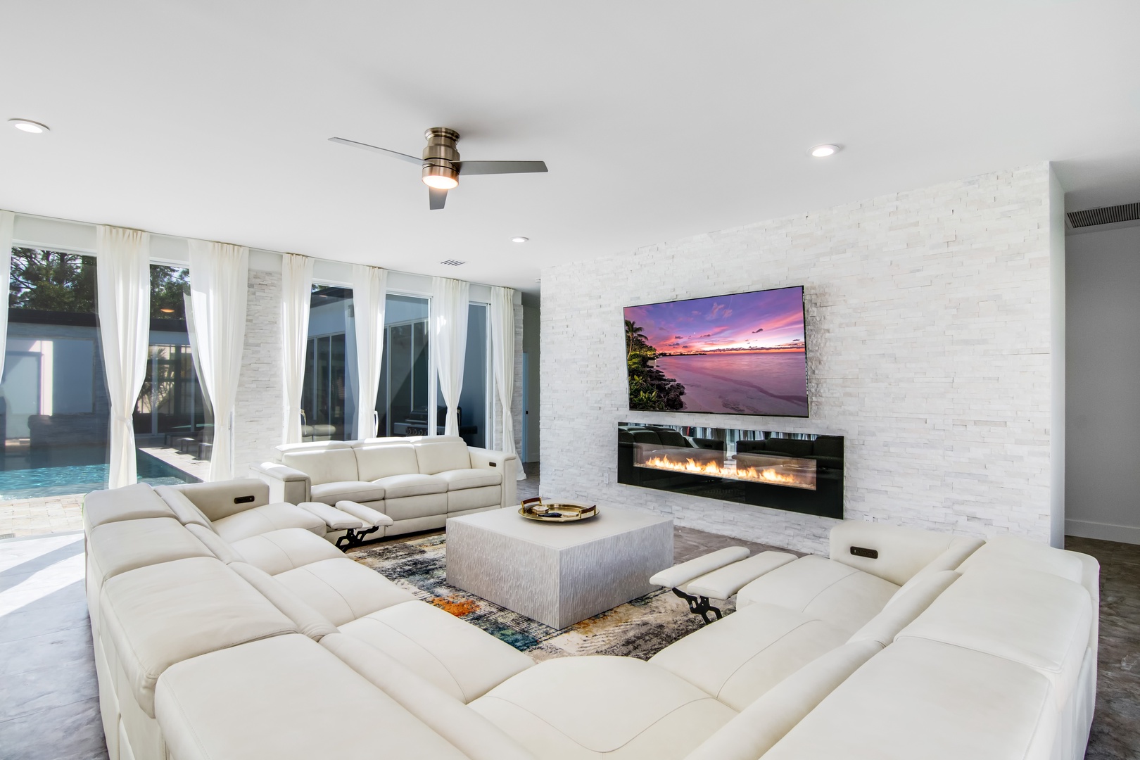 Modern spacious living area with TV