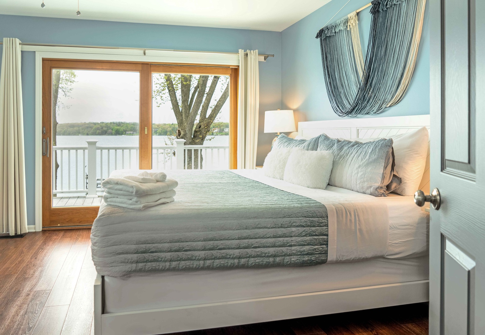 This second-floor bedroom offers a king-sized bed, a smart TV, & balcony access