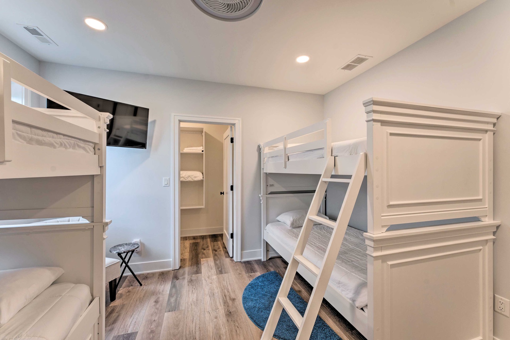 This bunk bedroom retreat offers twin bunks, a twin trundle, & Smart TV