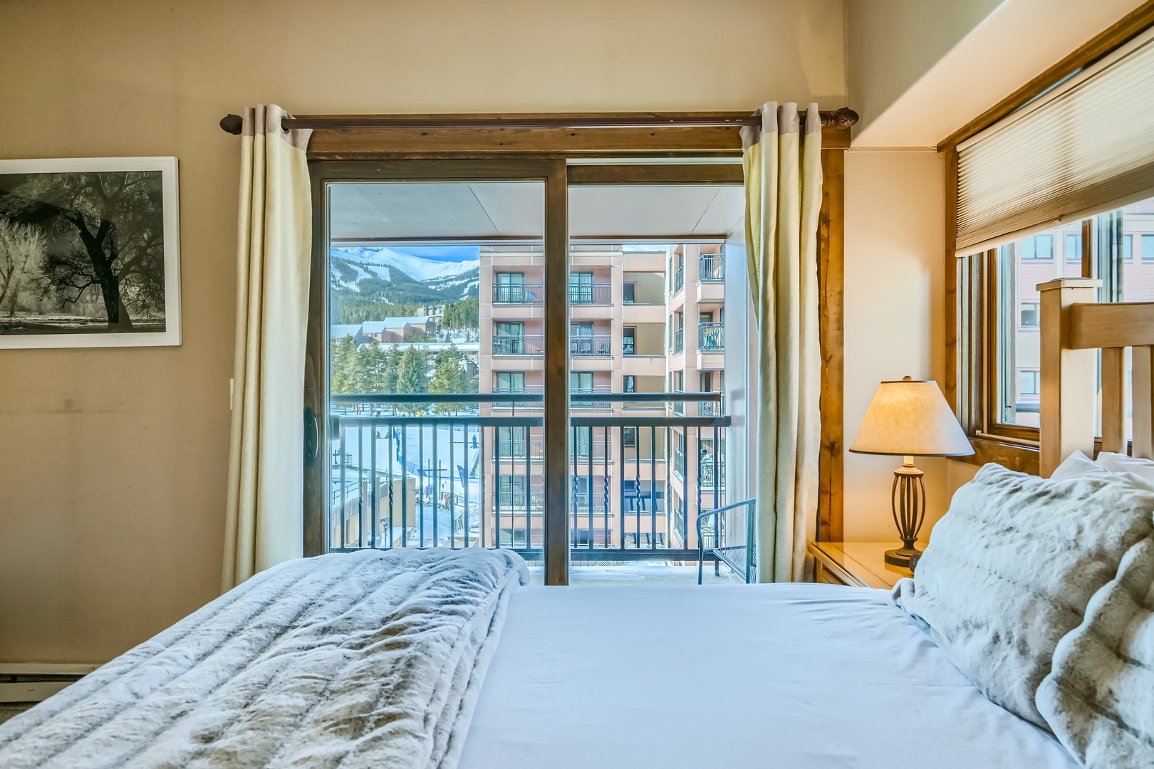 The private bedroom features a plush queen bed & stunning balcony views