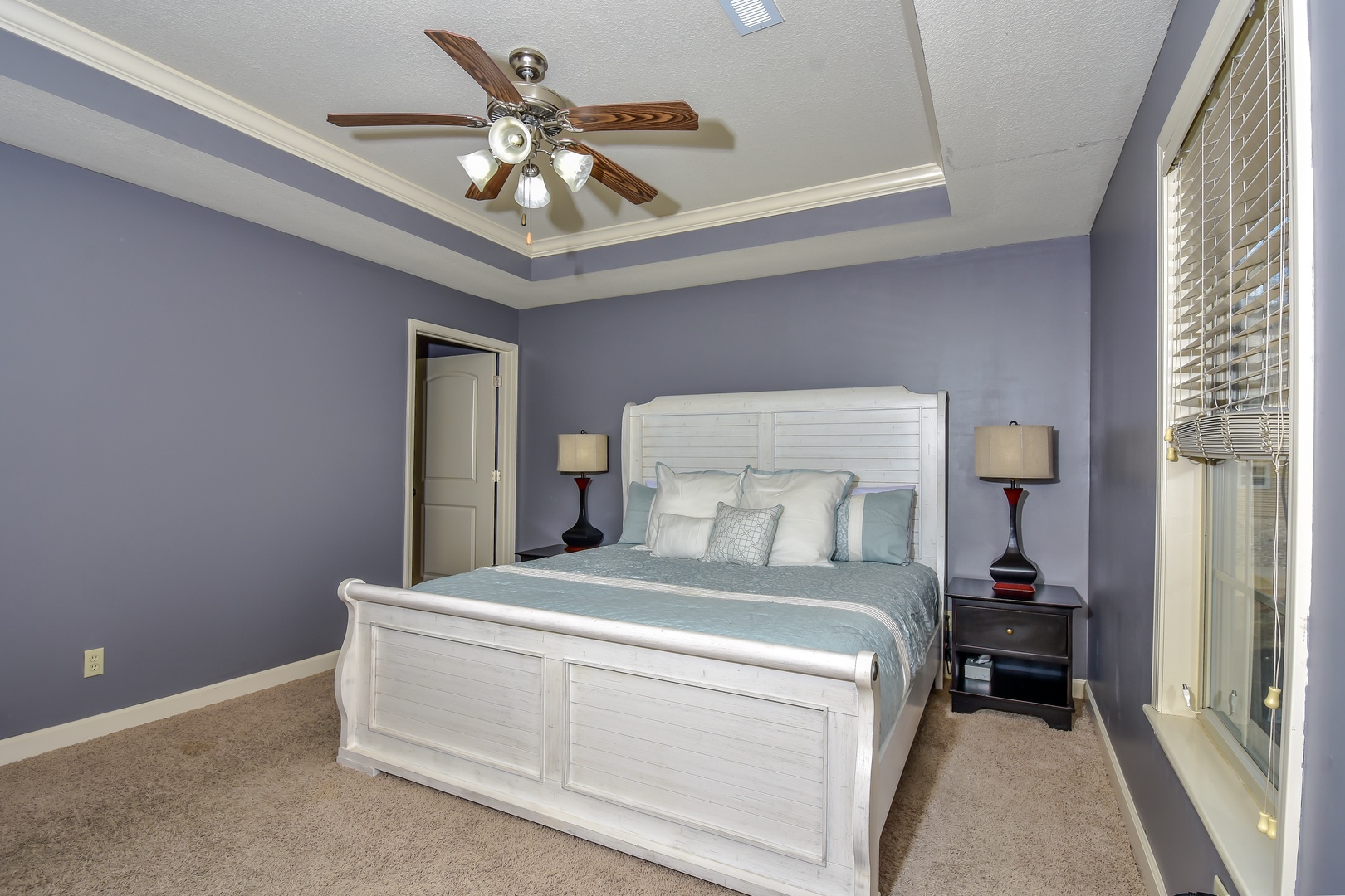 The serene master suite boasts a plush king bed, private ensuite, & Smart TV