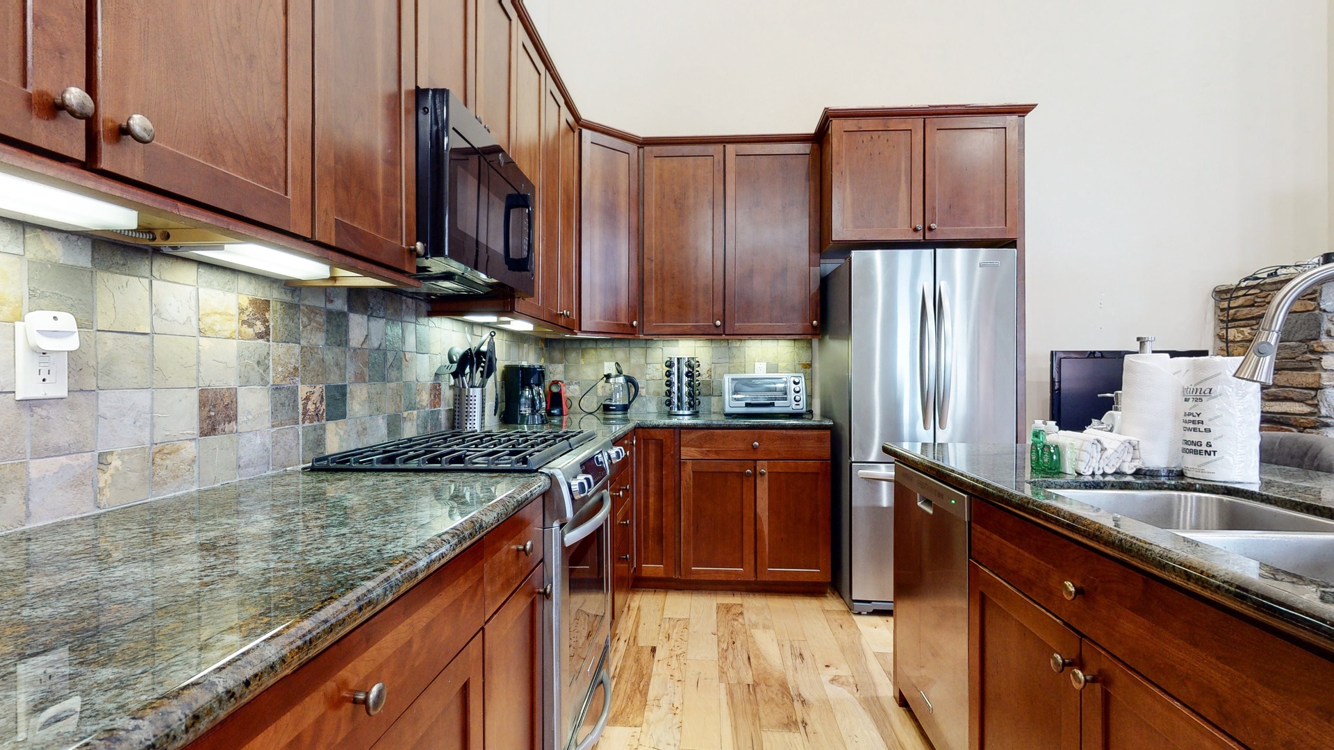 Kitchen with drip coffee maker, blender, dishwasher, gas stovetop and more