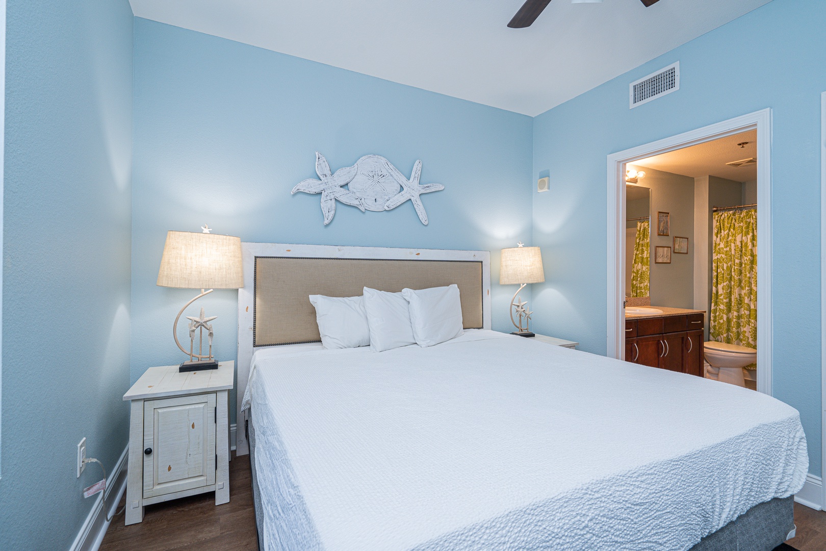 The coastal chic suite boasts a plush king bed, private ensuite, & TV