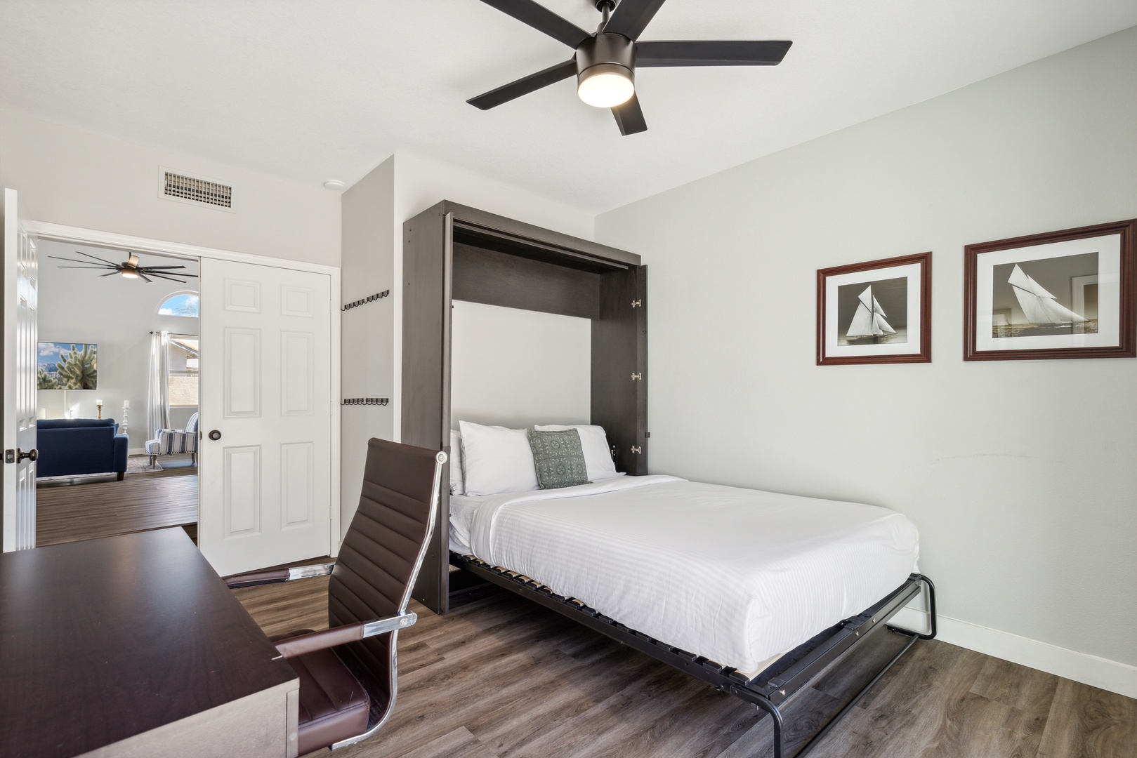 Bedroom 1 with queen murphy bed, workspace, and patio access