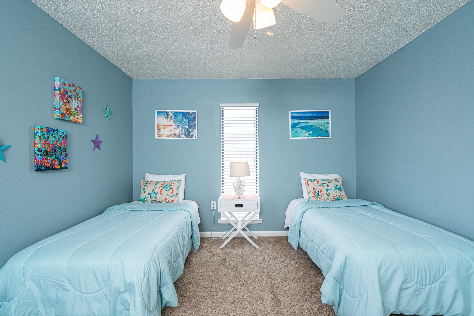 The 1st of 2 upper-level bedrooms is ideal for kids, featuring a pair of plush twin beds