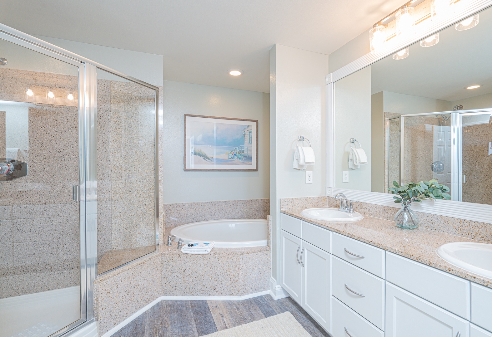 The king ensuite features a dual vanity, glass shower, & soaking tub