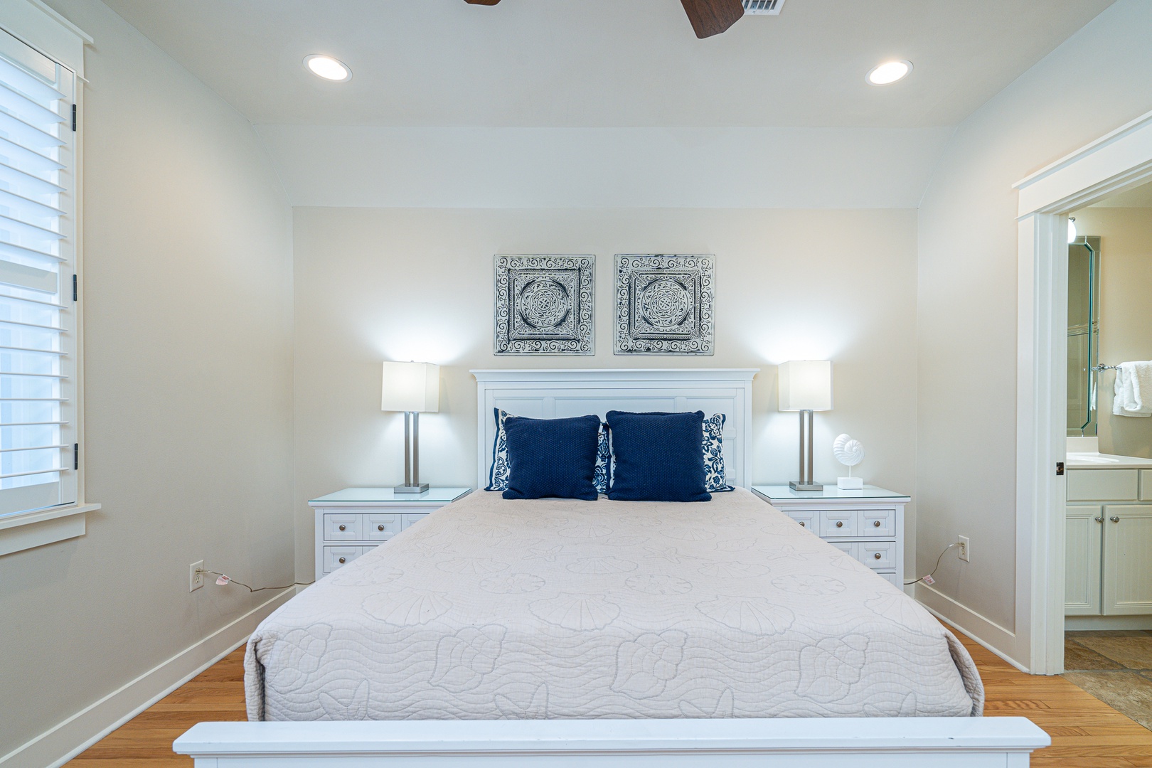 This 2nd-floor bedroom features a plush queen bed & private ensuite