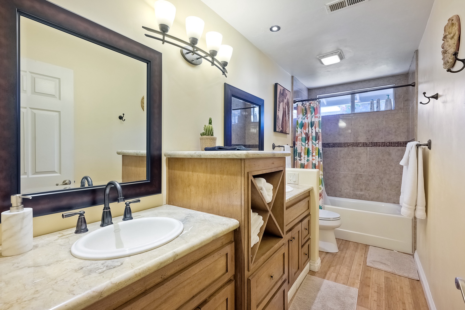 The full bathroom showcases a doubly vanity & shower/tub combo