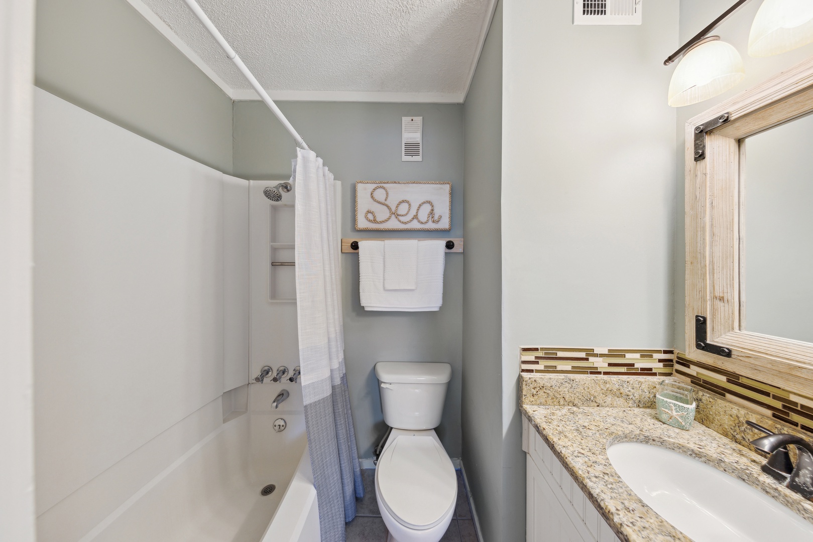 The queen ensuite bathroom includes a single vanity & shower/tub combo