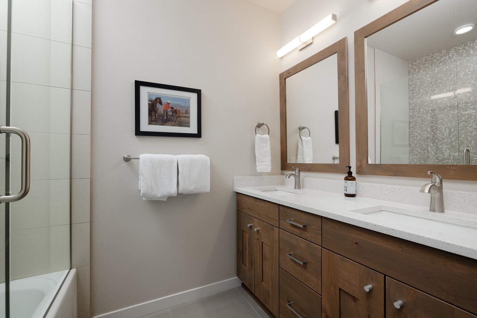 The 2nd-floor hall bath offers a double vanity & shower/tub combo