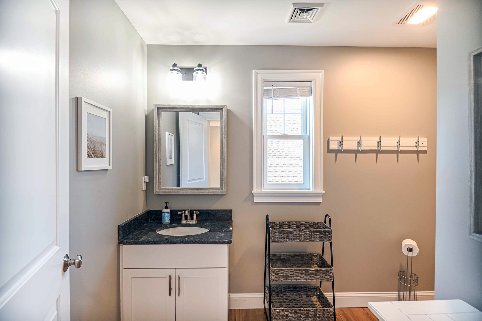 The upstairs full bath features a single vanity & walk-in shower