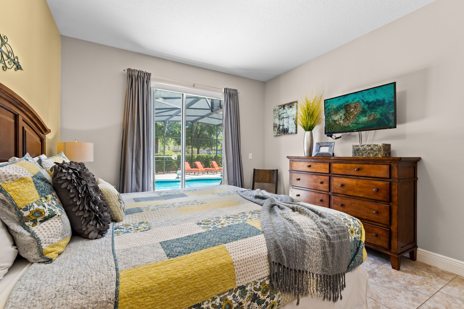 Bedroom 1 with king bed, Smart TV, patio access, and ensuite bathroom
