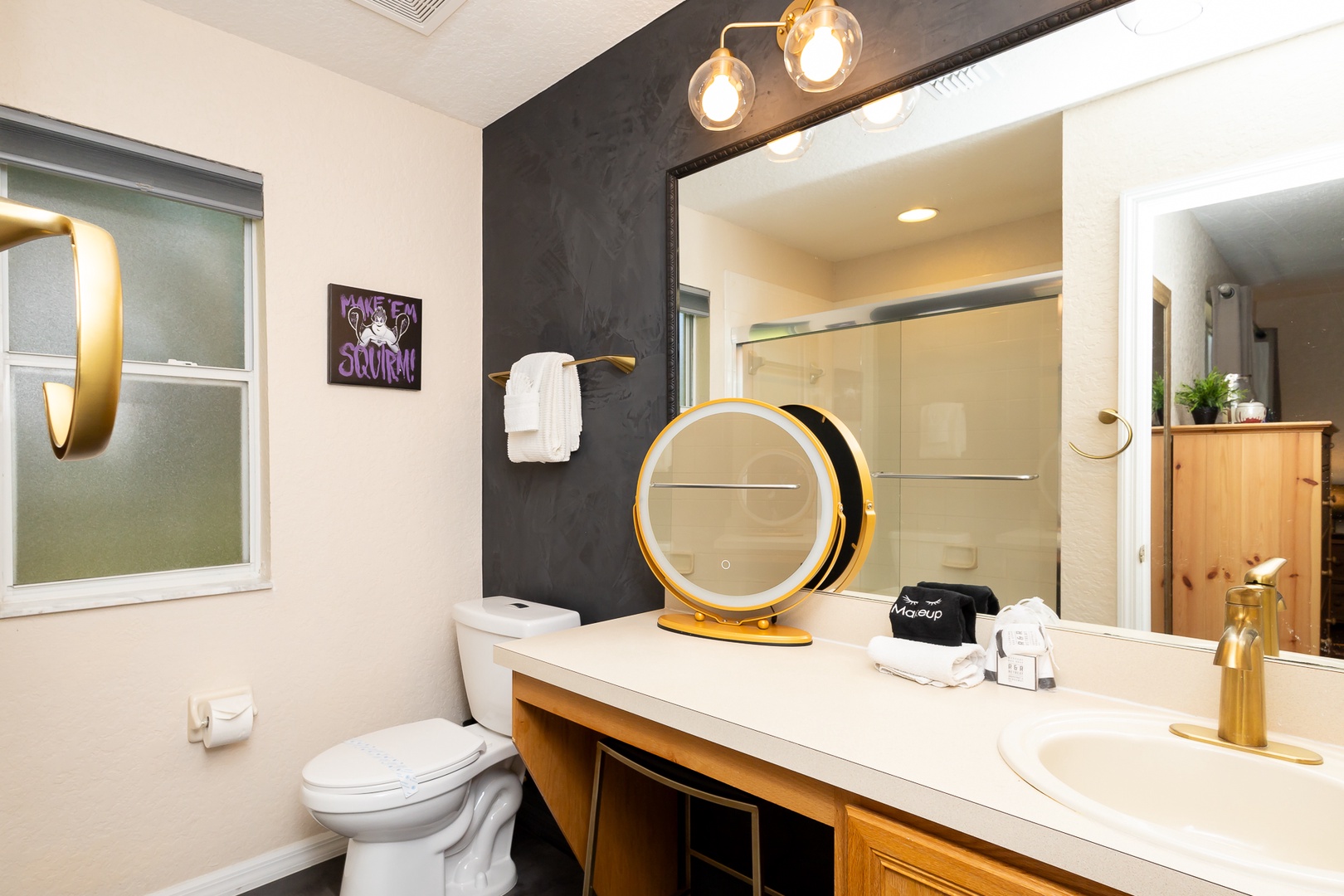 The ensuite off the king bedroom features a single vanity & shower/tub combo