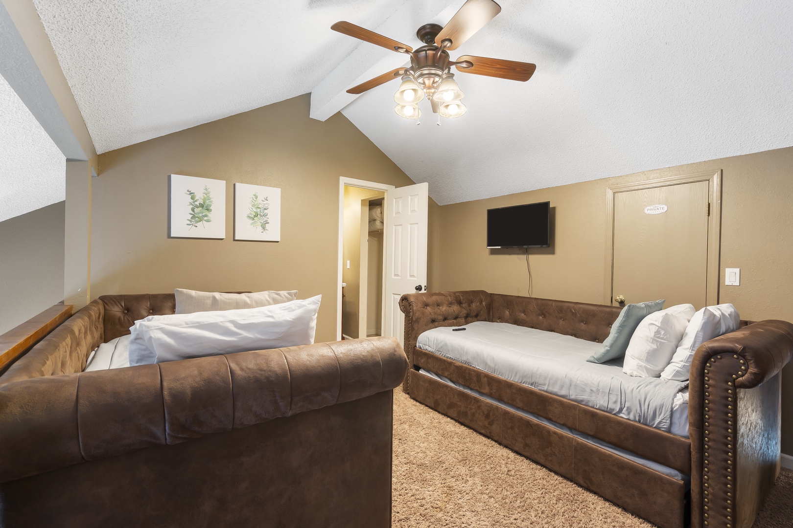 The loft bedroom offers 2 twin beds with trundles, private ensuite, & Smart TV