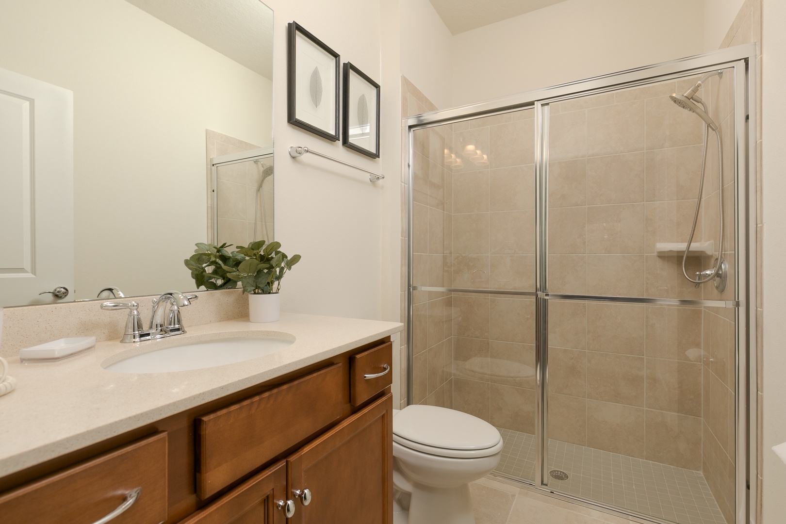 This full bathroom on the first floor includes a single vanity & glass shower