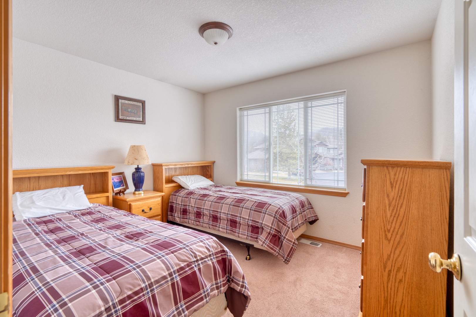 A pair of plush twin beds awaits in this second-floor bedroom