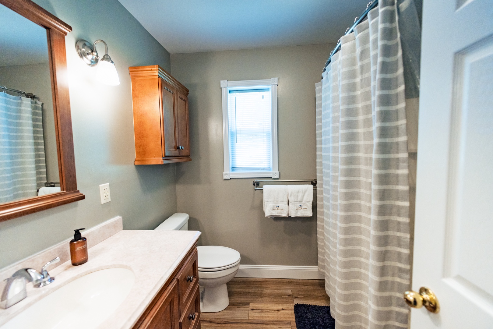 The 1st floor ensuite bath offers a single vanity & shower/tub combo