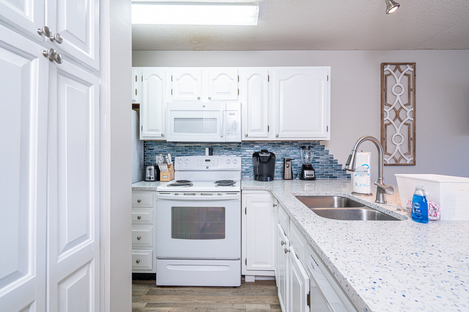 The open kitchen offers ample storage space & all the comforts of home
