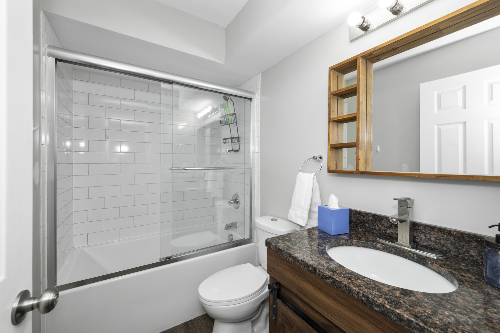 The lower-level full bathroom includes a single vanity & shower/tub combo