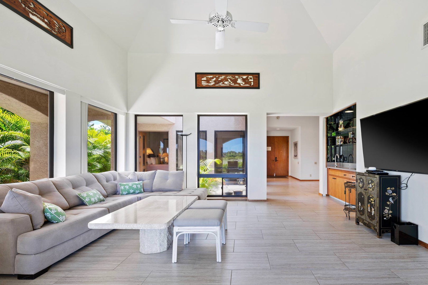 Spacious living room with 75" Smart HDTV, golf course view and lanai access
