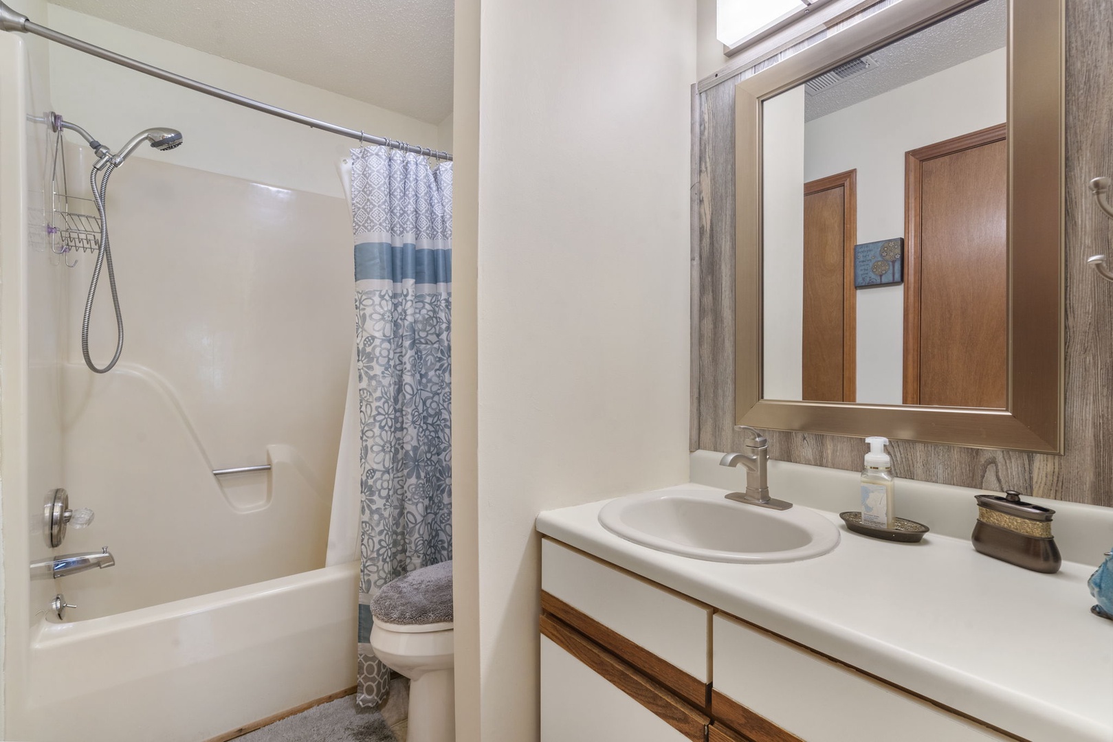 The king en suite offers an oversized single vanity & shower/tub combo