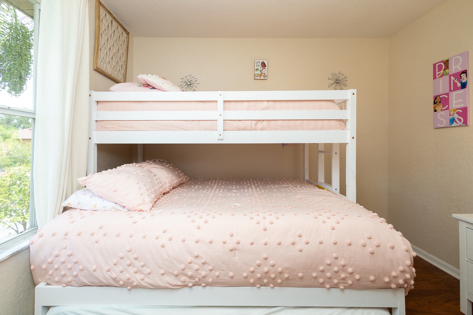 Drift into a nap in this bedroom’s twin-over-queen bunkbed with twin trundle