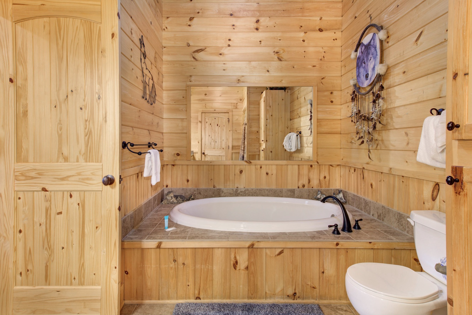 This Jack & Jill ensuite includes a single vanity, soaking tub, & shower