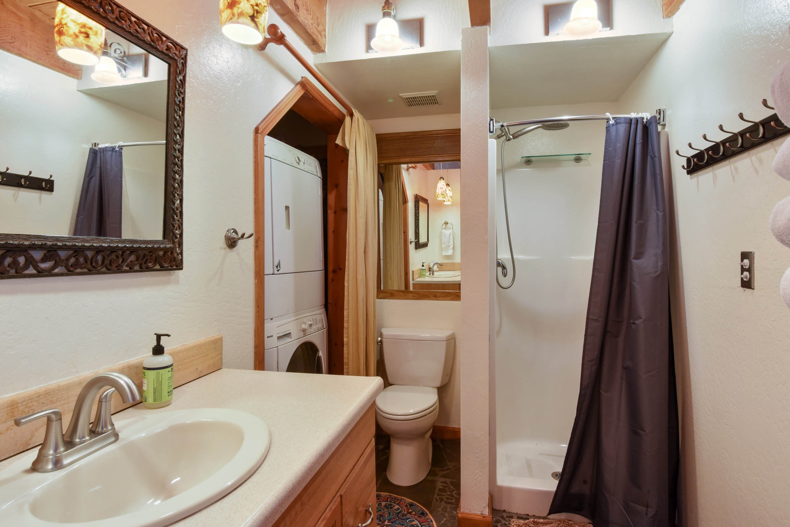 Full bathroom with standing shower, washer and dryer
