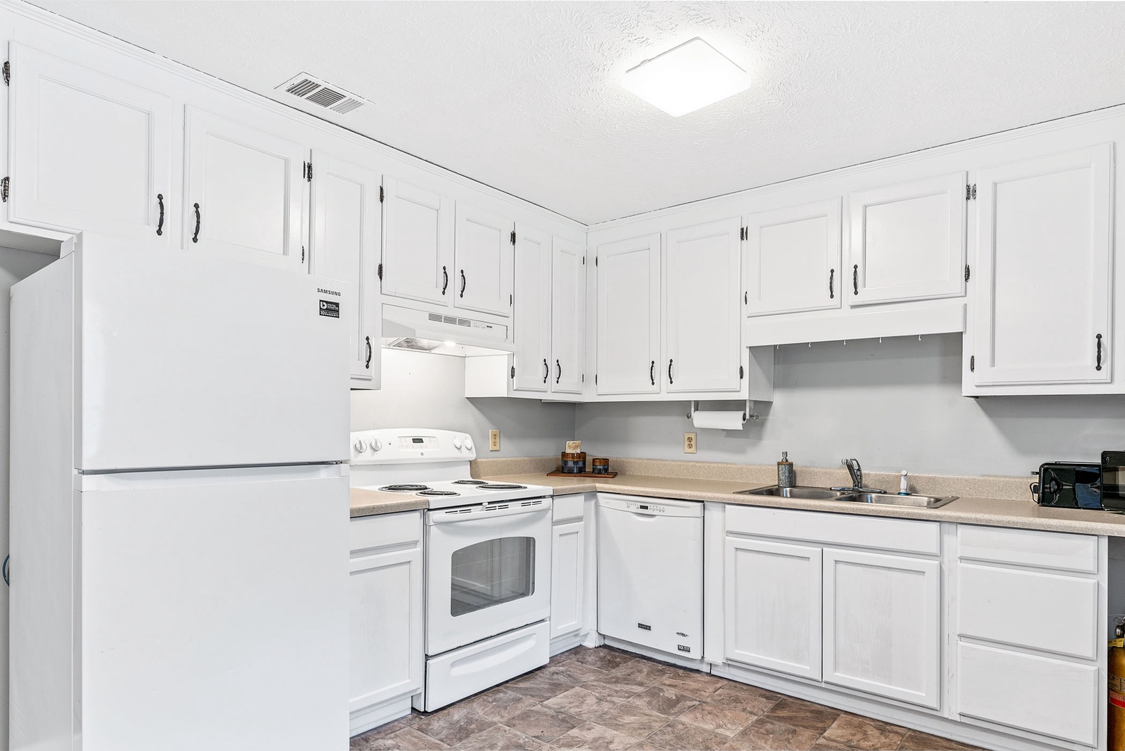 The sunny kitchen offers ample storage space & great amenities