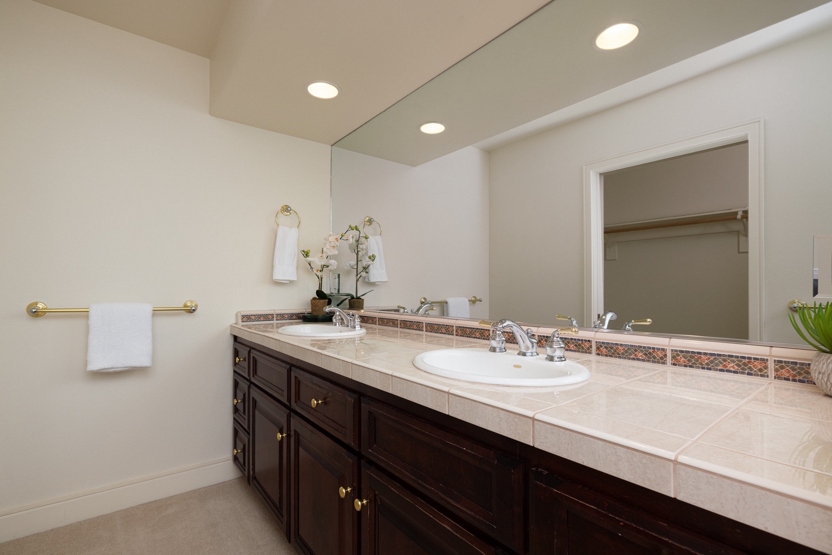 A large double vanity, shower, & walk-in closet await in the king ensuite