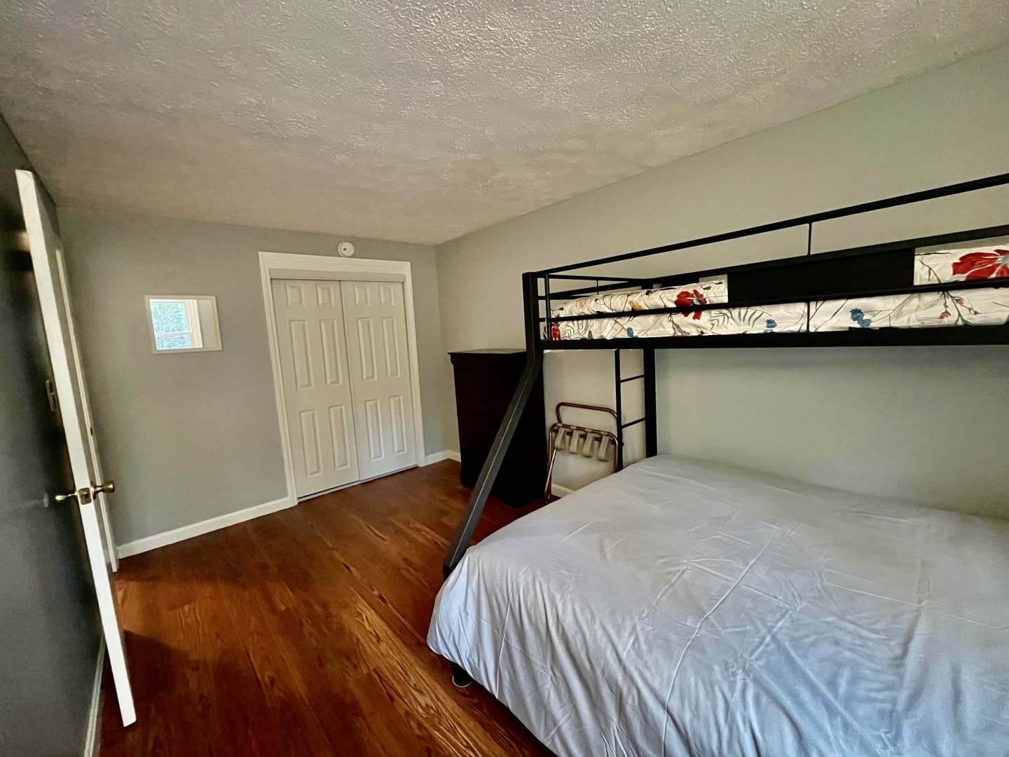 This bedroom retreat offers twin over queen bunkbed and cozy reading area