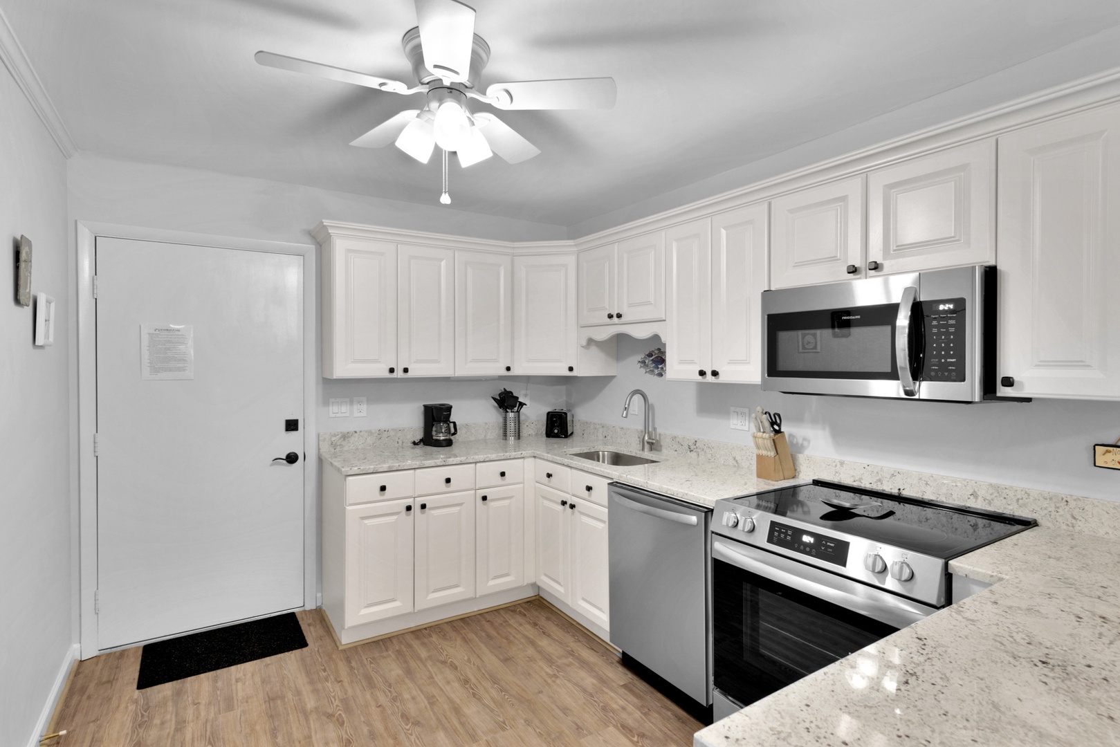 The bright, airy kitchen offers ample space & all the comforts of home