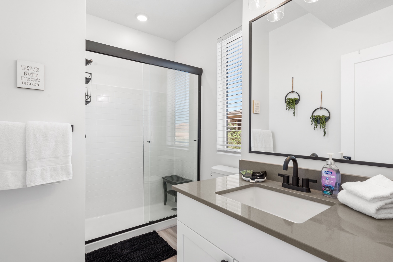 A single vanity & glass shower await in this 2nd-floor ensuite bath