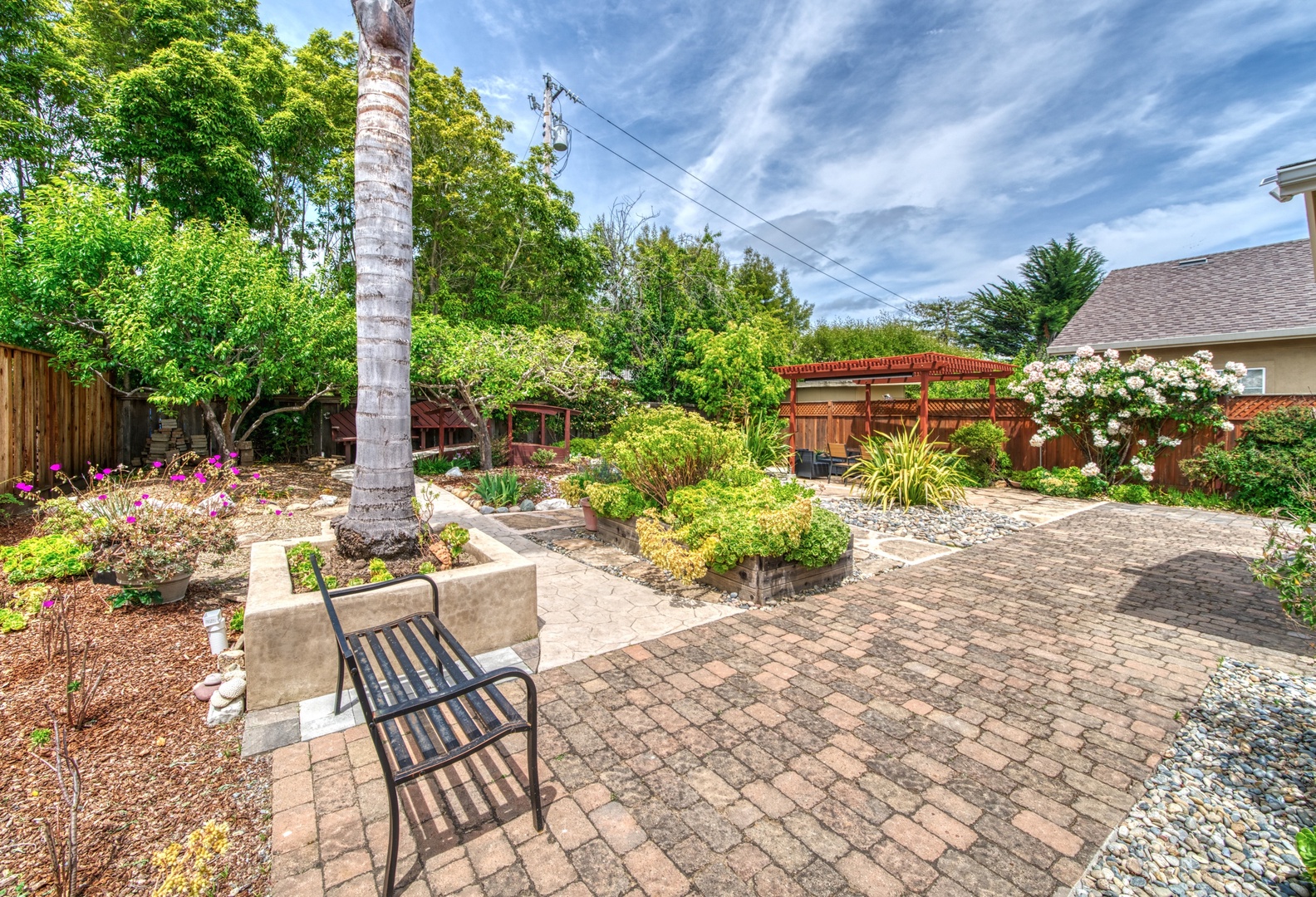 Lounge the day away or enjoy a stroll in the tranquil backyard oasis