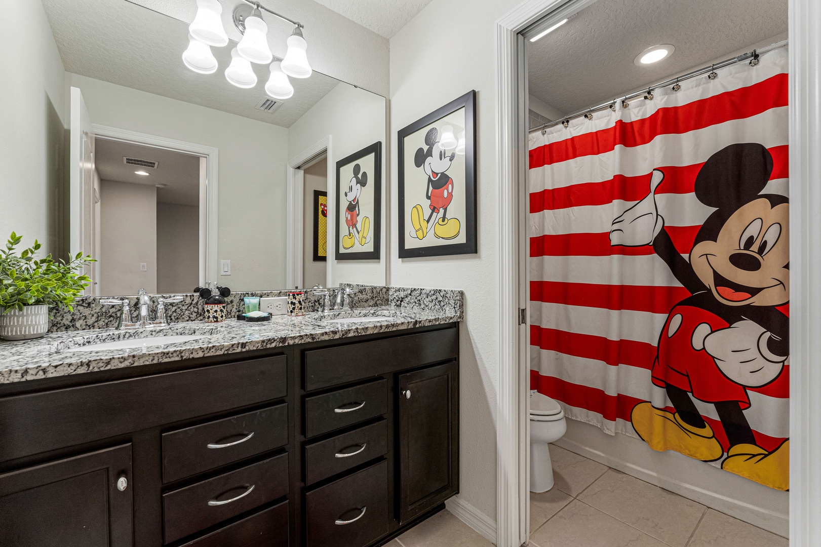 Freshen up in this shared full bathroom, featuring a shower/tub combo