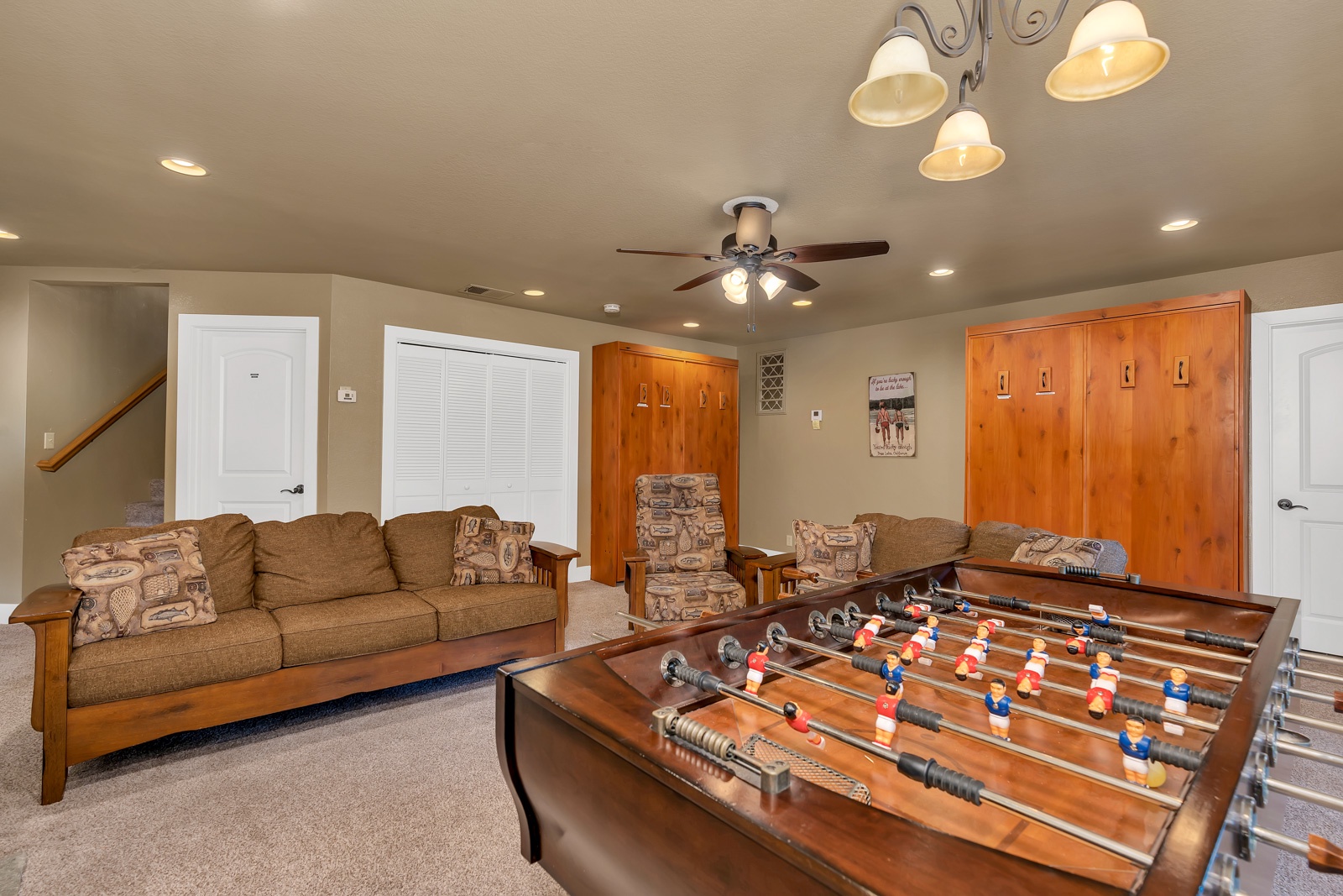 The lower-level game room includes two queen Murphy beds