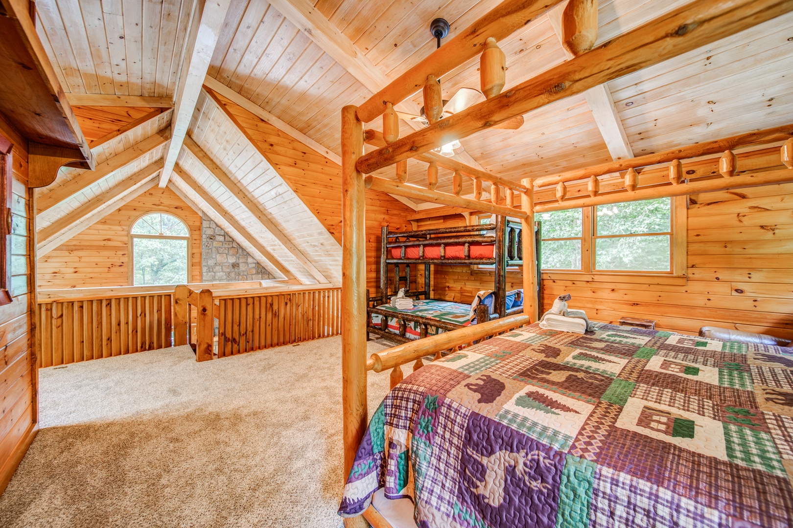 Loft sleeping area, with king bed, twin-over-full bunks, & attached bathroom
