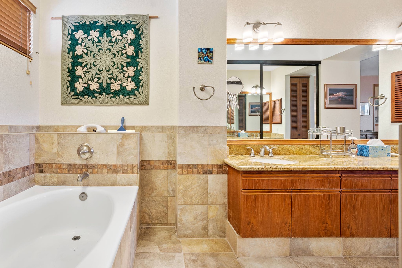 En suite bathroom with dual sinks, soaking tub, and standing shower