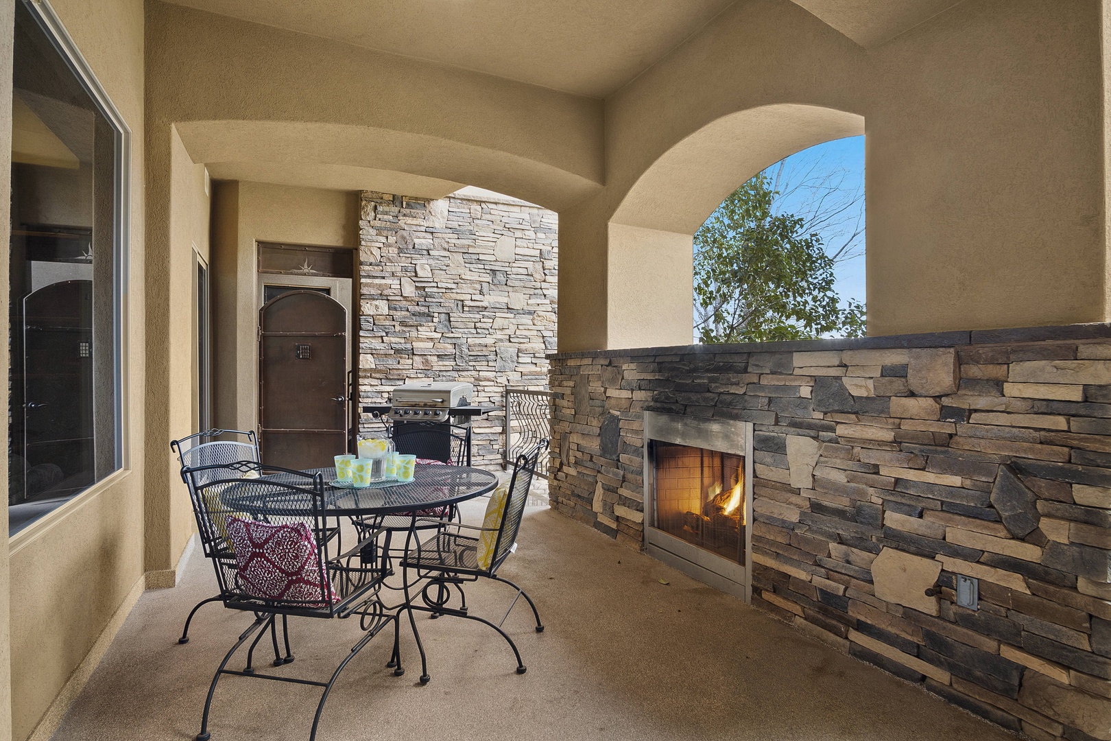 Terrace with outdoor dining, fireplace, and gas BBQ gril