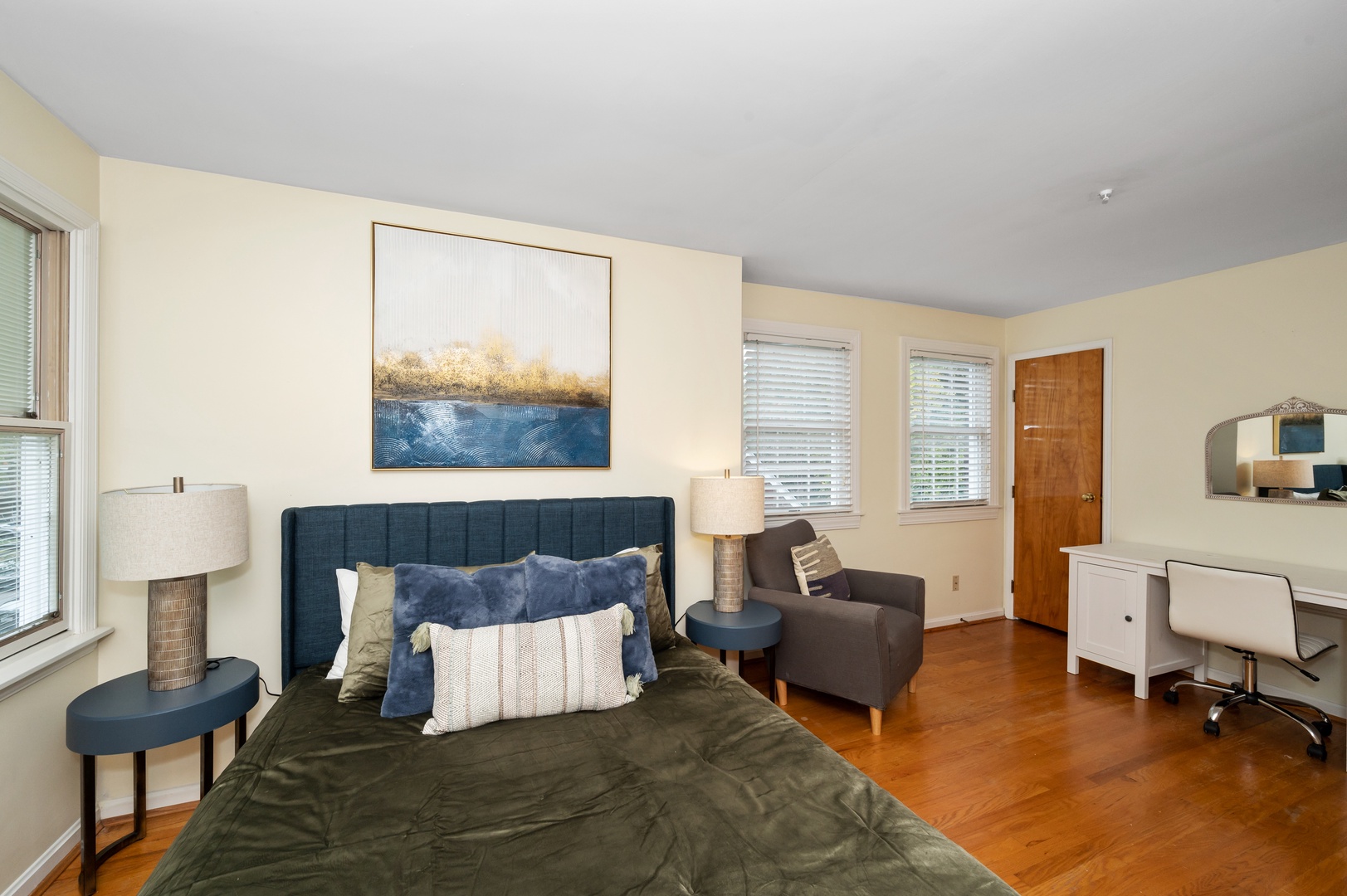 This 2nd floor bedroom offers a queen bed, desk workspace, & chic sitting area