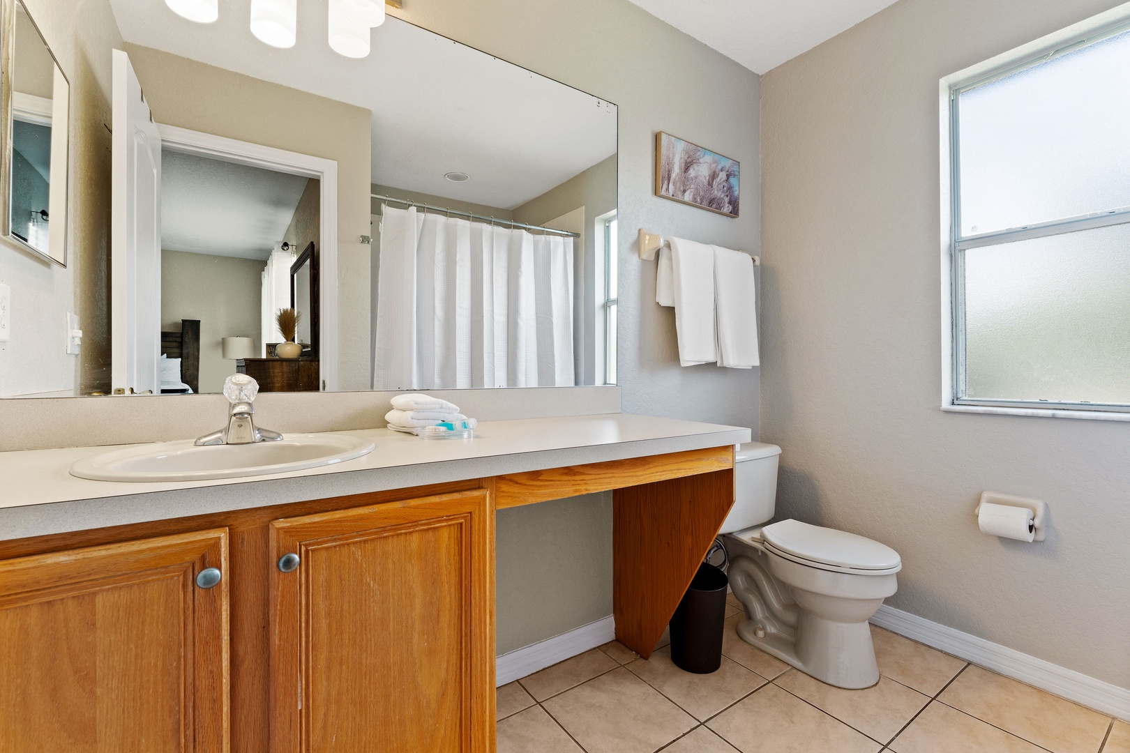 The king en suite offers a single vanity & shower/tub combo
