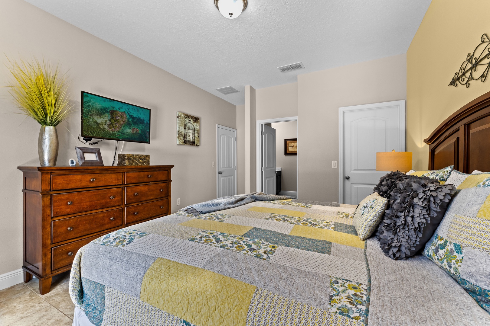 Bedroom 1 with king bed, Smart TV, patio access, and ensuite bathroom
