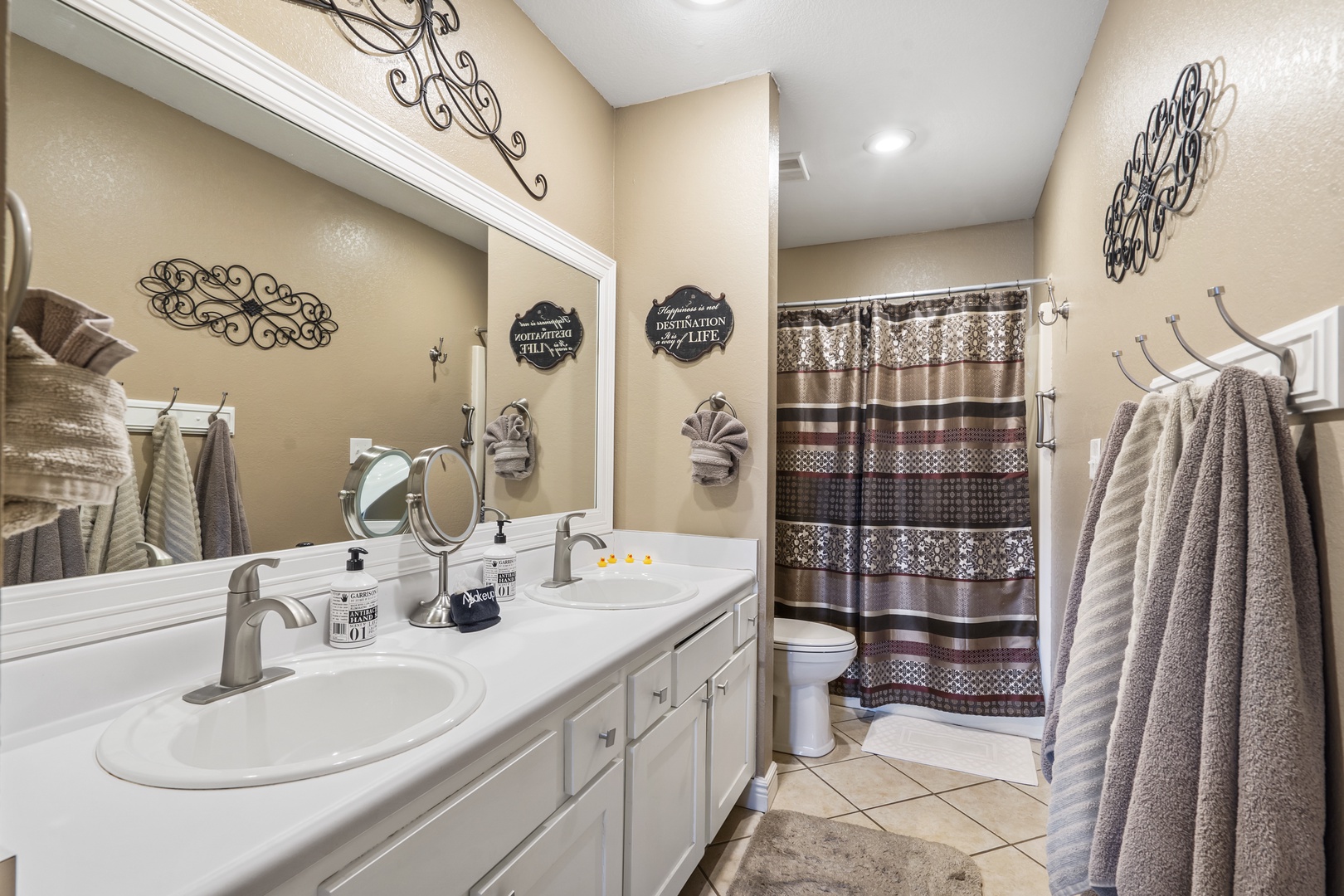 Dual vanities & a shower/tub combo await in the king ensuite bath