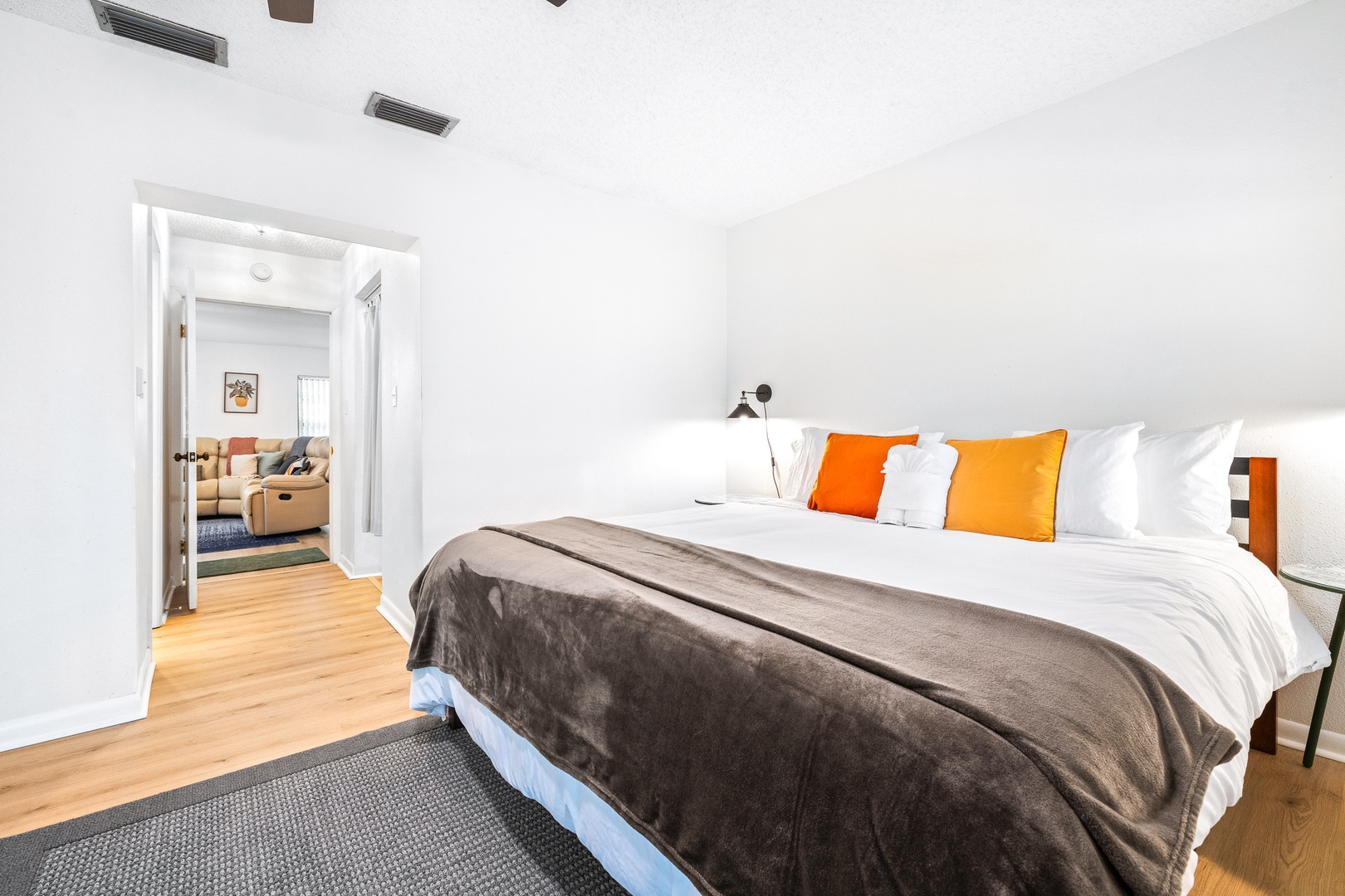 The spacious master bedroom boasts a king bed, smart TV, & patio access