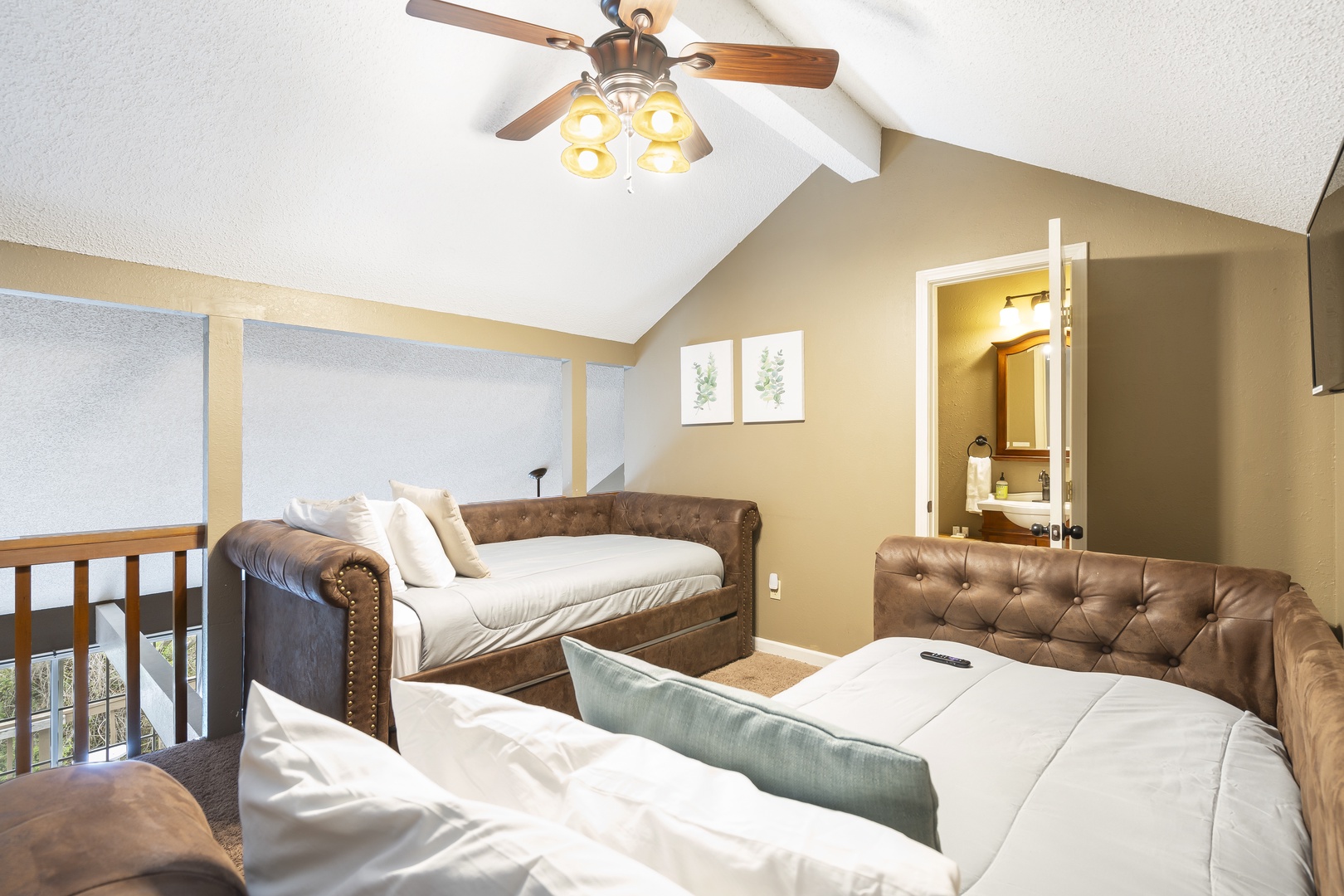 The loft bedroom offers 2 twin beds with trundles, private ensuite, & Smart TV