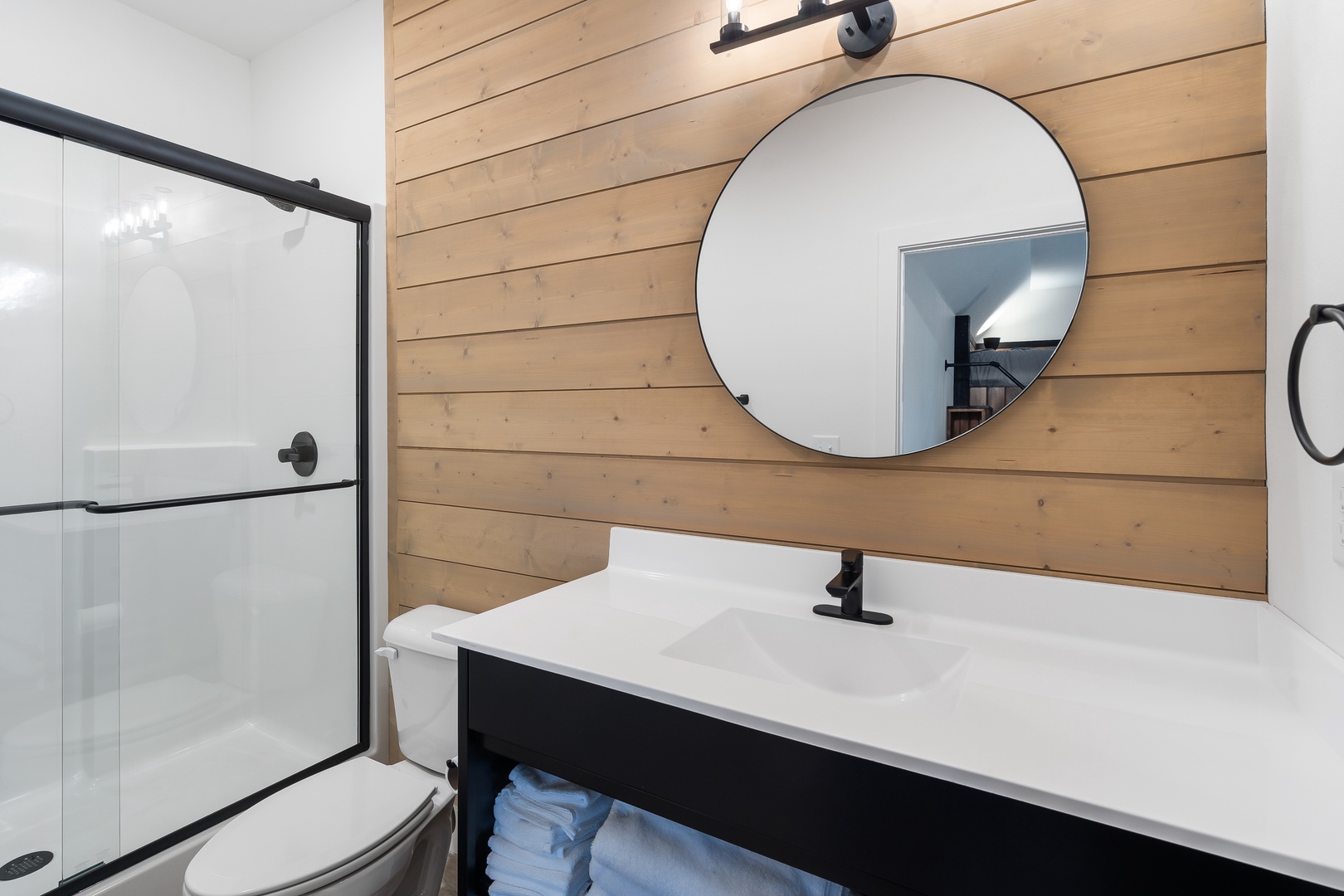 The 3rd bedroom’s ensuite bath offers a single vanity & glass shower