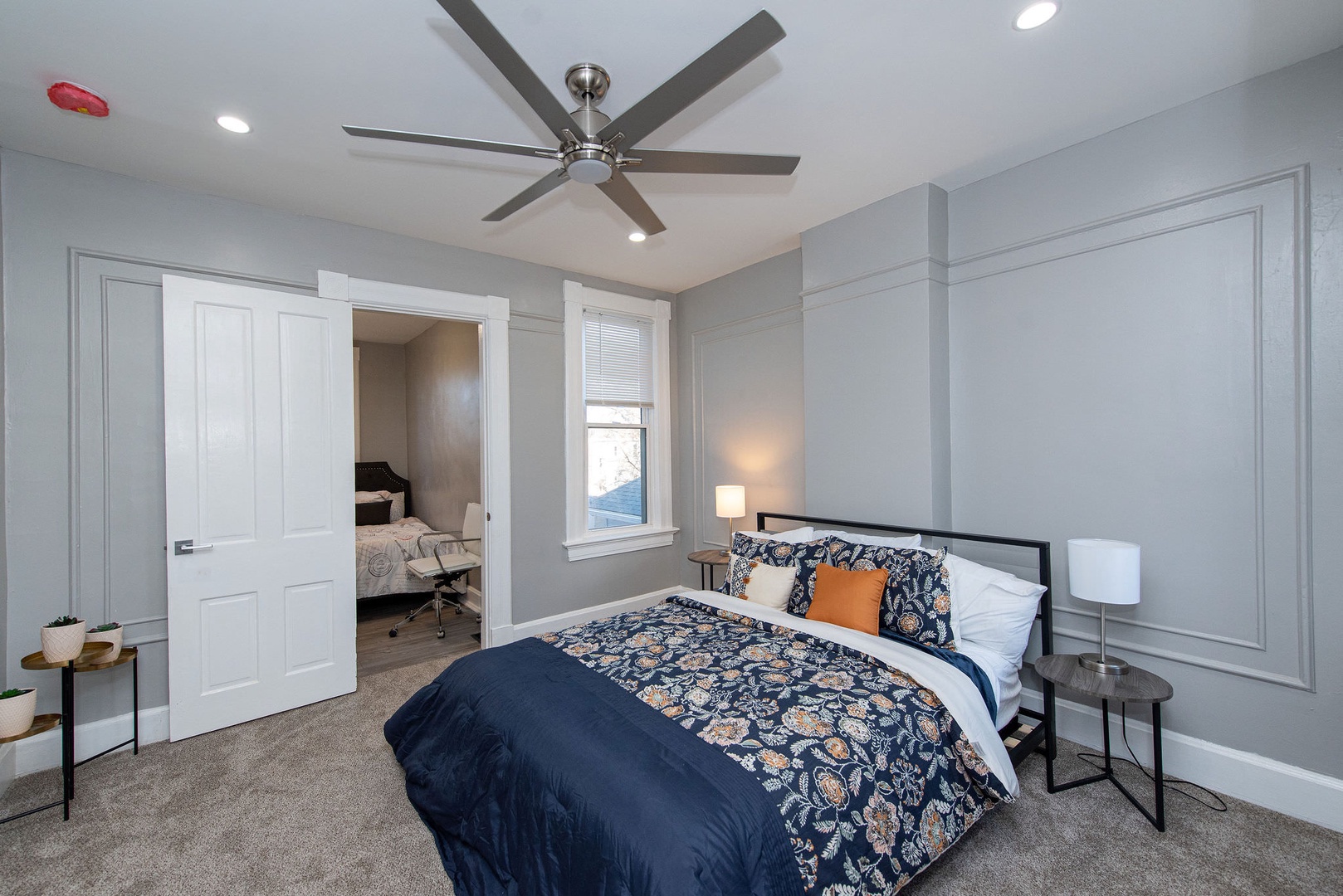 Suite 2 – The 2nd of 3 bedrooms includes a queen bed, Smart TV, & ceiling fan