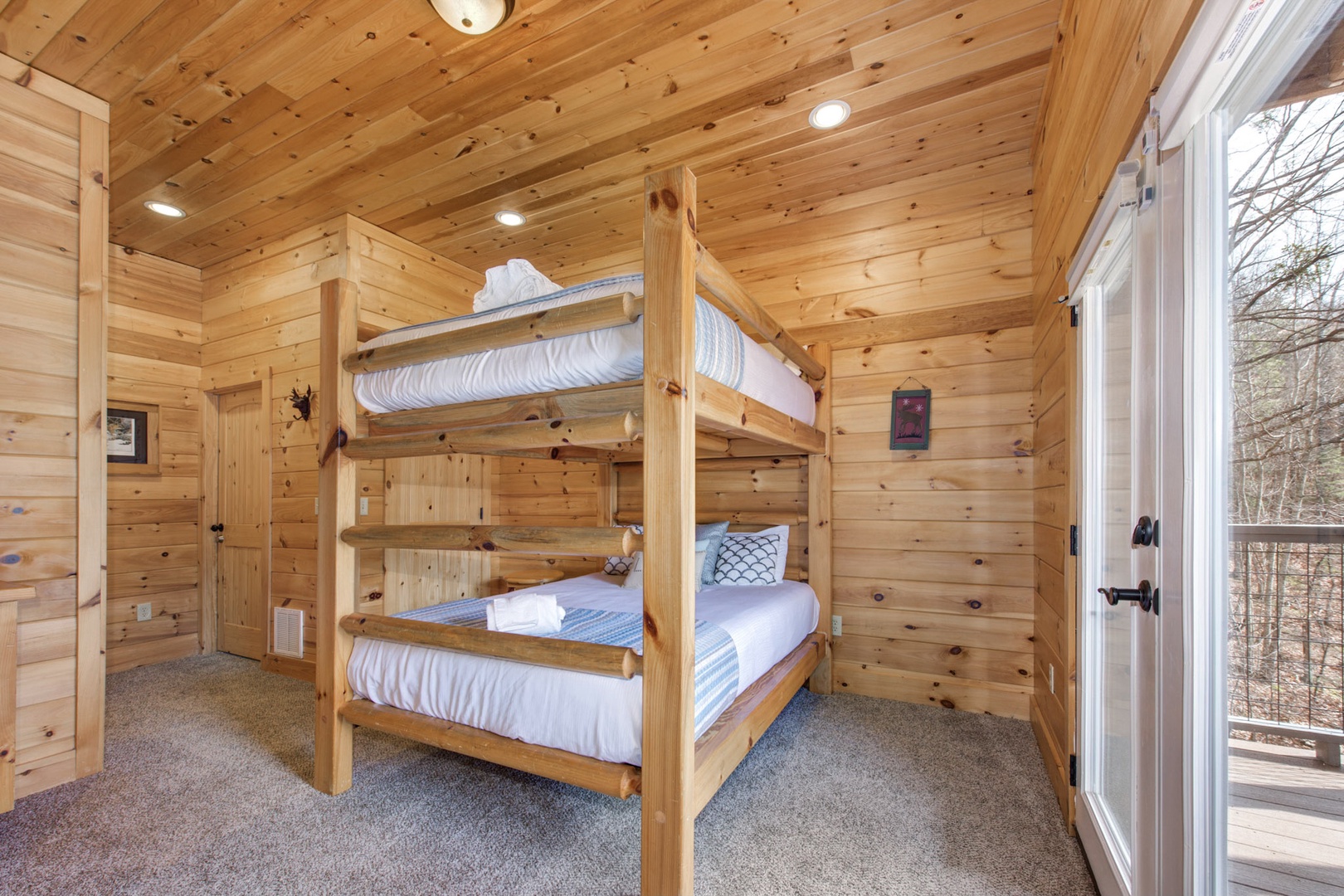 This lower-level retreat offers a private ensuite, Smart TV, & full over full bunks