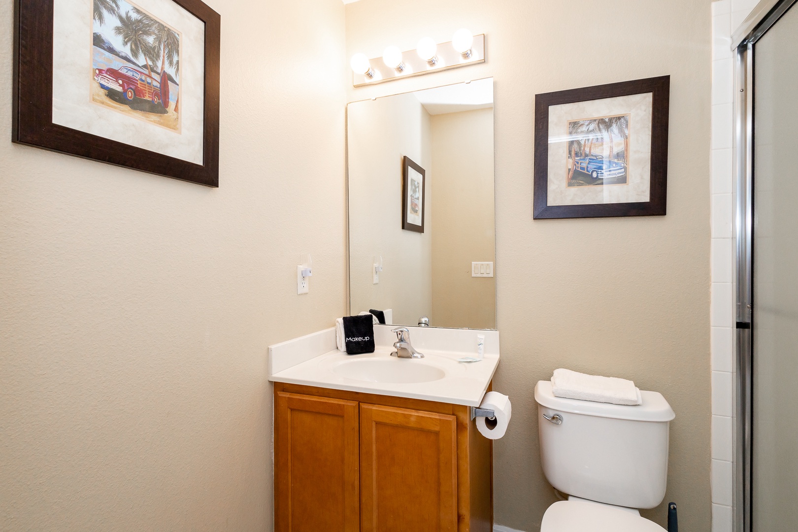 The full en suite bathroom includes a single vanity & glass shower